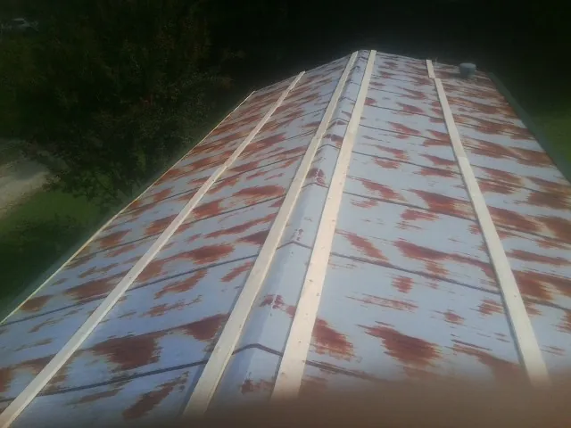 Rusted metal roof panels with new wood purlins before replacement — Storm Damage Roof Repair in Marion Center by Roofing Brothers