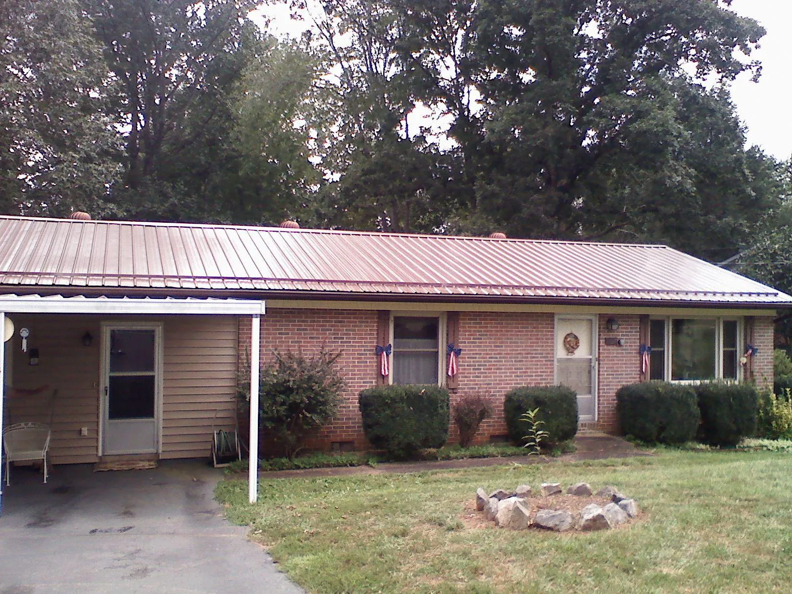 Bronze metal roof and carport on a brick ranch home — Roof Repair work by our crew in Marion Center