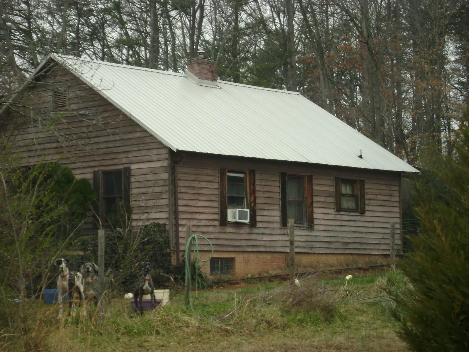 White metal roof on an old wood sided farmhouse, from a Metal Roof Installation job in Marion Center
